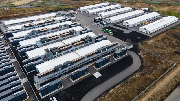 Aerial view of a large data center facility with rows of server buildings cooling units and paved access roads in Keflavik Reykjanesbaer Iceland. Aerial view of a large data center facility with rows of server buildings cooling units and paved access roads in Keflavik Reykjanesbaer Iceland.