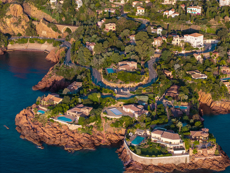 Aerial view of Le Trayas featuring luxury villas with swimming pools nestled among rocky cliffs and greenery along the Mediterranean coastline in Saint Raphael Provence Alpes Cote d Azur France. Aerial view of Le Trayas featuring luxury villas with swimming pools nestled among rocky cliffs and greenery along the Mediterranean coastline in Saint Raphael Provence Alpes Cote d Azur France.