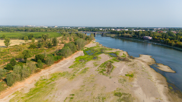 Aerial view of the Po River with low water levels due to drought and summer heatwave exposing sediments beaches and the riverbed in Castelvetro Piacentino Emilia Romagna Italy. Aerial view of the Po River with low water levels due to drought and summer heatwave exposing sediments beaches and the riverbed in Castelvetro Piacentino Emilia Romagna Italy.