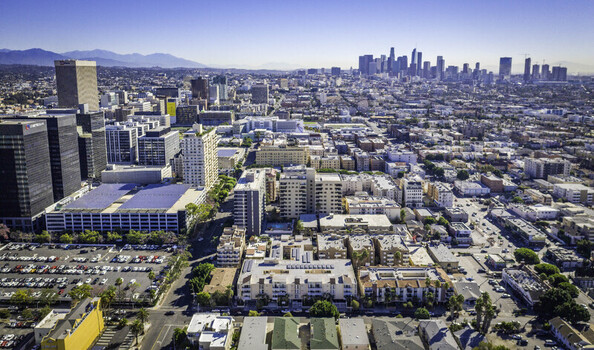 Los Angeles United States 19 October 2018 Aerial view of the city skyline with solar panels on parking structures and residential buildings in the foreground. Los Angeles United States 19 October 2018 Aerial view of the city skyline with solar panels on parking structures and residential buildings in the foreground.