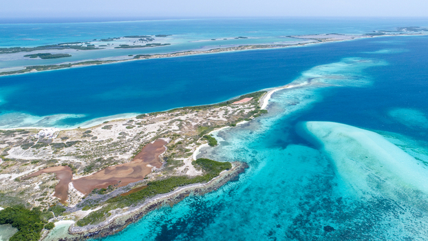 Aerial view of Los Roques archipelago with turquoise waters coral reefs and white sandbars in Los Roques Dependencias Federales Venezuela. Aerial view of Los Roques archipelago with turquoise waters coral reefs and white sandbars in Los Roques Dependencias Federales Venezuela.