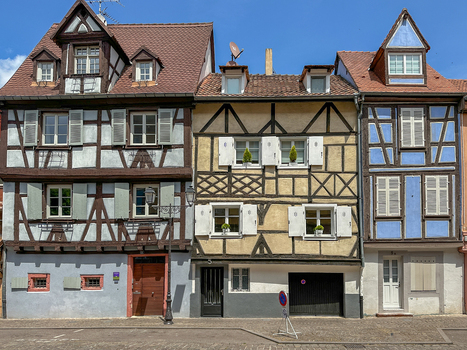 View of traditional half timbered houses with colorful facades and wooden shutters in the historic town of Colmar Grand Est France.