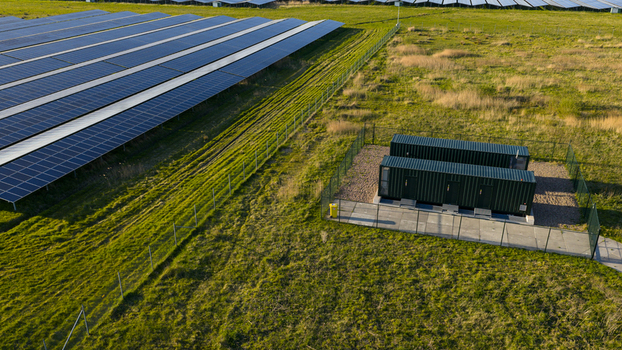 Aerial view of Solar park Delfzijl featuring rows of photovoltaic panels and power storage units on green fields in Farmsum Groningen Netherlands. Aerial view of Solar park Delfzijl featuring rows of photovoltaic panels and power storage units on green fields in Farmsum Groningen Netherlands.