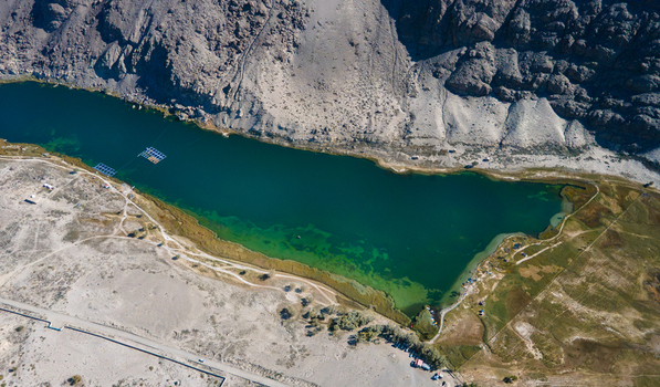 Aerial view of Blind Lake Sarfaranga Shigar with its deep turquoise waters nestled against rugged rocky mountains and arid desert terrain in Skardu Gilgit Pakistan. Aerial view of Blind Lake Sarfaranga Shigar with its deep turquoise waters nestled against rugged rocky mountains and arid desert terrain in Skardu Gilgit Pakistan.