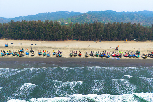 Cox s Bazar Bangladesh 10 March 2026 Aerial view of traditional colorful fishing boats lined up on the sandy shore of Cox s Bazar beach with lush green trees and hills in the background. Cox s Bazar Bangladesh 10 March 2026 Aerial view of traditional colorful fishing boats lined up on the sandy shore of Cox s Bazar beach with lush green trees and hills in the background.