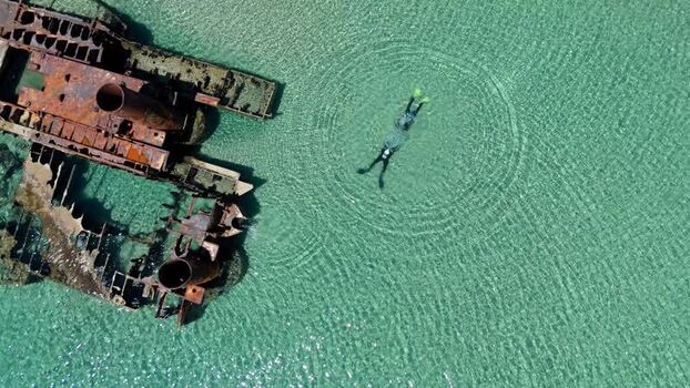 Aerial view of Shipwreck Epanomi and a swimmer Greece.