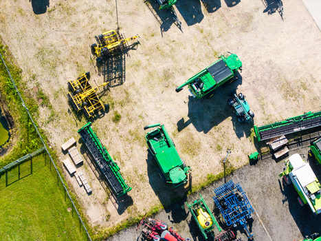 Kekava Latvia 05 July 2026 Aerial view of an agricultural machinery dealership featuring various green combine harvesters tractors and farming equipment parked on a gravel lot. Kekava Latvia 05 July 2026 Aerial view of an agricultural machinery dealership featuring various green combine harvesters tractors and farming equipment parked on a gravel lot.