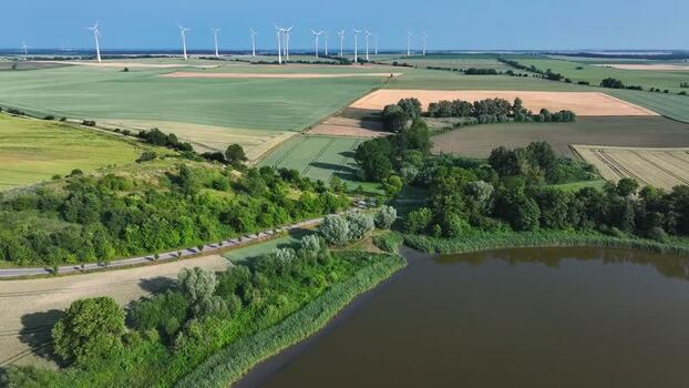 Aerial view of wind turbines and fields in Uckermark Germany.