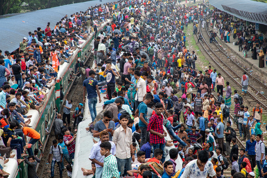 Dhaka Bangladesh 15 June 2018 View of thousands of commuters crowded on train roofs and platforms at Airport Railway Station during the Eid holiday rush. Dhaka Bangladesh 15 June 2018 View of thousands of commuters crowded on train roofs and platforms at Airport Railway Station during the Eid holiday rush.