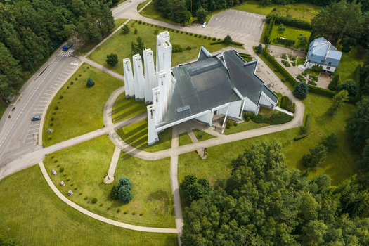 Aerial view of the Church of the Holy Virgin Mary of Fatima with its white spires and dark roof surrounded by green lawns and trees in Elektrenai Vilnius County Lithuania. Aerial view of the Church of the Holy Virgin Mary of Fatima with its white spires and dark roof surrounded by green lawns and trees in Elektrenai Vilnius County Lithuania.