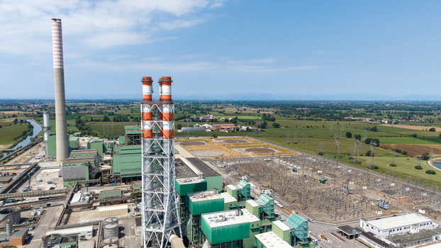 Aerial view of the TTEP Tavazzano thermal power plant and TERNA electrical substation with tall chimneys and industrial infrastructure in Tavazzano con Villavesco Lombardy Italy.