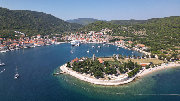 Aerial view of the Saint Jerome church on the Prirovo peninsula and a cruise ship in the harbor of Vis Split Dalmatia County Croatia. Aerial view of the Saint Jerome church on the Prirovo peninsula and a cruise ship in the harbor of Vis Split Dalmatia County Croatia.