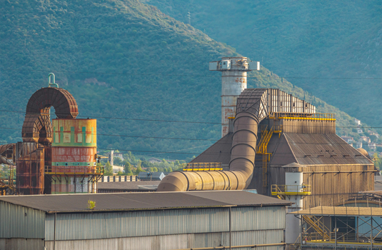 Aerial view of heavy industrial ventilation and air filtration equipment with massive exhaust ducts at a manufacturing plant in Brescia Lombardy Italy.