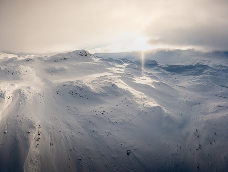 Aerial view of the snow covered Gaustablikk Fjellresort area in the mountains featuring vast white slopes and soft golden sunlight over the pristine winter terrain Rjukan Telemark Norway. Aerial view of the snow covered Gaustablikk Fjellresort area in the mountains featuring vast white slopes and soft golden sunlight over the pristine winter terrain Rjukan Telemark Norway.