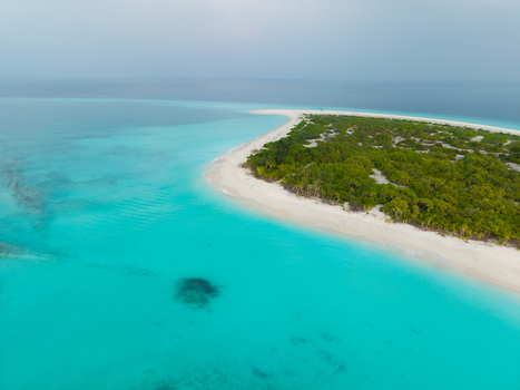 Aerial view of a vibrant island paradise where turquoise waters meet lush greenery under a tranquil sky Hoarafushi Thiladhunmathee Uthuruburi Maldives. Aerial view of a vibrant island paradise where turquoise waters meet lush greenery under a tranquil sky Hoarafushi Thiladhunmathee Uthuruburi Maldives.