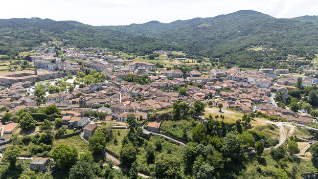 Aerial view of the historic town of Allariz with its traditional stone houses terracotta rooftops and surrounding green hills in Allariz Province of Ourense Spain. Aerial view of the historic town of Allariz with its traditional stone houses terracotta rooftops and surrounding green hills in Allariz Province of Ourense Spain.