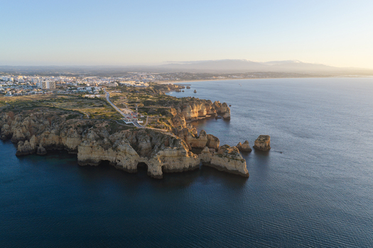 Aerial view of the dramatic limestone cliffs and rock formations at Ponta da Piedade in Lagos Faro District Portugal.