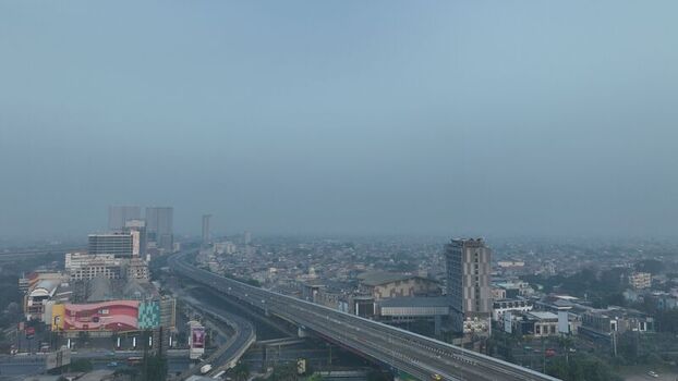 Bekasi Barat West Java Indonesia 20 June 2026 Aerial view of the elevated toll road winding through the dense urban landscape of Bekasi Barat with high rise buildings and hazy skies. Bekasi Barat West Java Indonesia 20 June 2026 Aerial view of the elevated toll road winding through the dense urban landscape of Bekasi Barat with high rise buildings and hazy skies.
