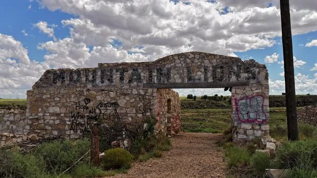 View of Two Guns ruins with stone walls and graffiti United States.