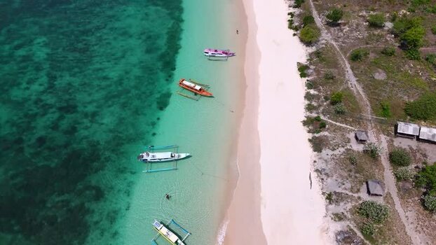 Aerial view of Pink Beach and boats on turquoise water Indonesia. Aerial view of Pink Beach and boats on turquoise water Indonesia.