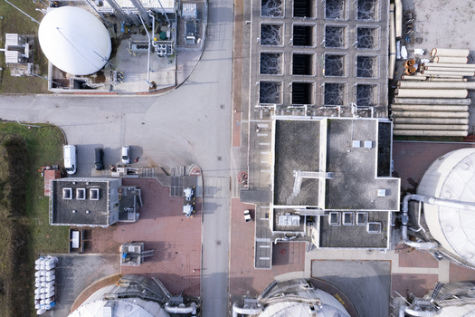Aerial view of the wastewater treatment plant featuring large white storage tanks aeration basins and industrial infrastructure in Richmond British Columbia Canada. Aerial view of the wastewater treatment plant featuring large white storage tanks aeration basins and industrial infrastructure in Richmond British Columbia Canada.