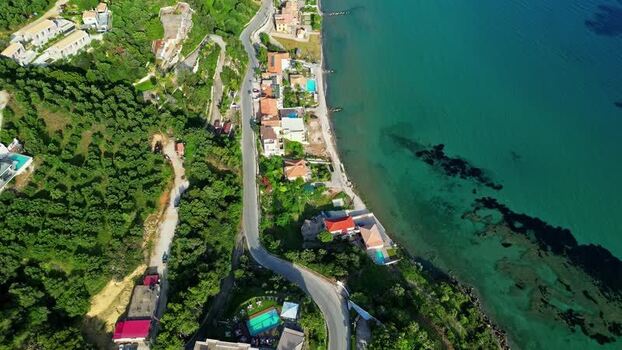 Aerial view of coastal road along the turquoise sea Greece.
