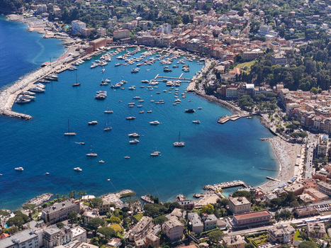 Aerial view of the harbor filled with numerous boats and yachts surrounded by colorful buildings and lush greenery in Santa Margherita Ligure Liguria Italy. Aerial view of the harbor filled with numerous boats and yachts surrounded by colorful buildings and lush greenery in Santa Margherita Ligure Liguria Italy.