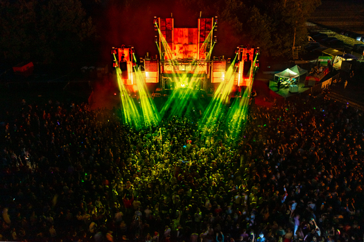 Herzogenaurach Germany 22 July 2022 Aerial view of the Open Beatz Festival main stage with bright laser lights and a large crowd at night. Herzogenaurach Germany 22 July 2022 Aerial view of the Open Beatz Festival main stage with bright laser lights and a large crowd at night.