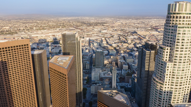 Aerial view of the Los Angeles skyline featuring modern skyscrapers and urban sprawl under a clear sky in Los Angeles California United States.