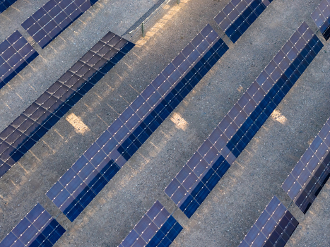 Aerial view of rows of photovoltaic solar panels arranged in a grid on a desert landscape with soft shadows in Enterprise Nevada United States. Aerial view of rows of photovoltaic solar panels arranged in a grid on a desert landscape with soft shadows in Enterprise Nevada United States.