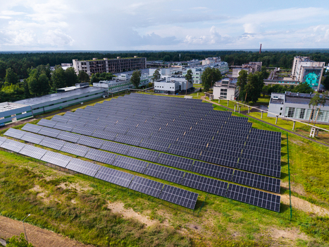 Olaine parish Latvia 04 July 2026 Aerial view of a large solar panel farm situated near industrial buildings and a forest. Olaine parish Latvia 04 July 2026 Aerial view of a large solar panel farm situated near industrial buildings and a forest.