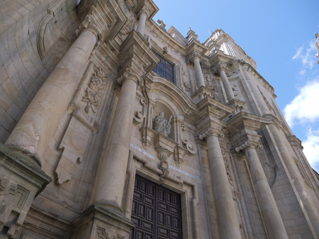 View of the ornate baroque facade of Igrexa da Santa Eufemia with detailed stone carvings columns and a large wooden door in Ourense Ourense Spain.