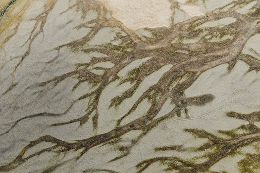 Aerial view of intricate glacial river patterns forming braided channels across the sandy landscape of Hofn Sveitarfelagid Hornaf Iceland.