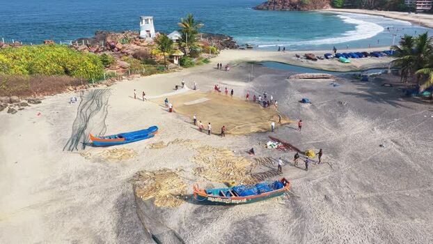 Aerial view of fishermen with nets on Kovalam beach India. Aerial view of fishermen with nets on Kovalam beach India.