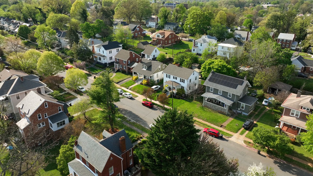 Aerial view of a quiet residential neighborhood with detached houses lush green trees and paved streets in Lynchburg Virginia United States.