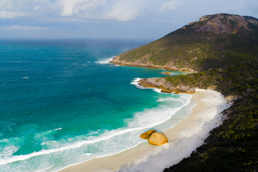 Aerial view of Two Peoples Bay Nature Reserve with white sand beach turquoise ocean rocky headlands and lush coastal vegetation in Albany Western Australia Australia.