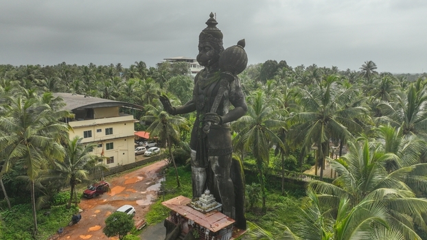 Aerial view of the massive Hanuman statue surrounded by lush palm trees and greenery in Udupi Karnataka India. Aerial view of the massive Hanuman statue surrounded by lush palm trees and greenery in Udupi Karnataka India.