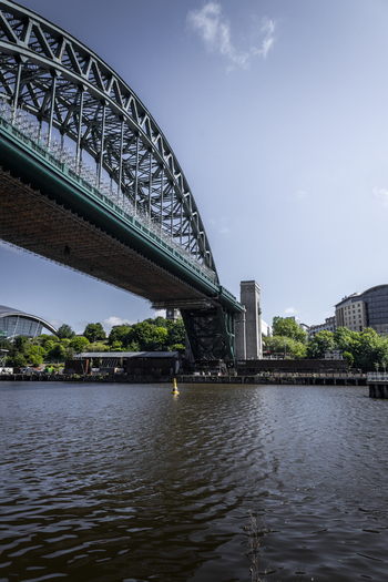 View of the Tyne Bridge spanning the River Tyne under a clear blue sky in Newcastle upon Tyne England United Kingdom. View of the Tyne Bridge spanning the River Tyne under a clear blue sky in Newcastle upon Tyne England United Kingdom.