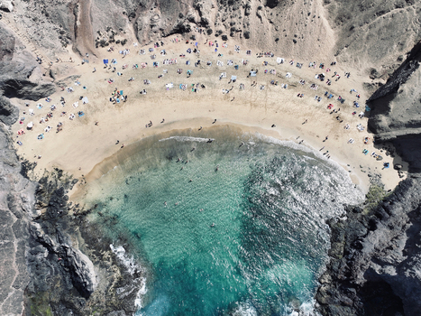 Aerial view of Papagayo Beach with turquoise water golden sand and volcanic cliffs in Lanzarote. Aerial view of Papagayo Beach with turquoise water golden sand and volcanic cliffs in Lanzarote.