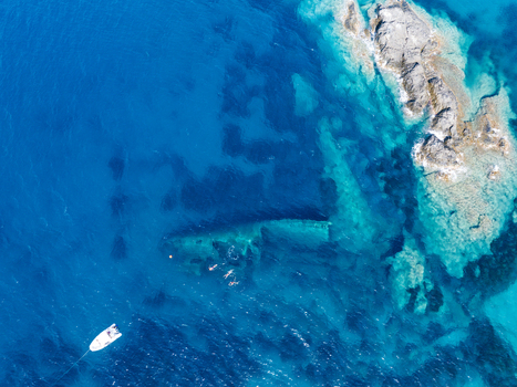 Aerial view of the Elviscot shipwreck submerged in the crystal clear blue waters of the Tyrrhenian Sea near the rocky coast of Pomonte Province of Livorno Italy.