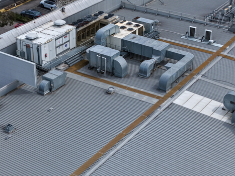 Melbourne VIC Australia 25 September 2026 Aerial view of industrial rooftop with HVAC units and ventilation ducts on a corrugated metal roof.