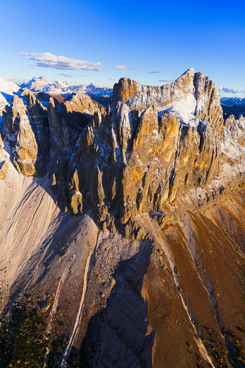 Aerial view of majestic Catinaccio and Roda de Vael piercing the skyline a symphony of gold and stone Trentino South Tyrol Italy.