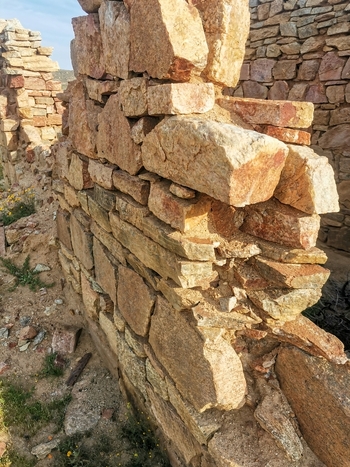 View of a weathered dry stone wall constructed from rough textured rocks in a rural setting showcasing traditional masonry techniques in Springbok Northern Cape South Africa. View of a weathered dry stone wall constructed from rough textured rocks in a rural setting showcasing traditional masonry techniques in Springbok Northern Cape South Africa.