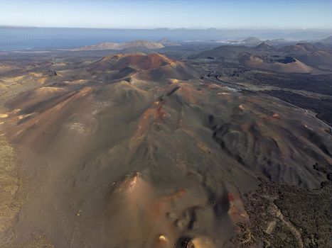 Aerial view of the volcanic craters and rugged lava fields of Timanfaya National Park Lanzarote Canarias Spain. Aerial view of the volcanic craters and rugged lava fields of Timanfaya National Park Lanzarote Canarias Spain.