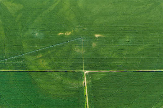 Aerial view of a circular irrigation system in a lush green agricultural field with geometric patterns in Hombourg Grand Est France. Aerial view of a circular irrigation system in a lush green agricultural field with geometric patterns in Hombourg Grand Est France.