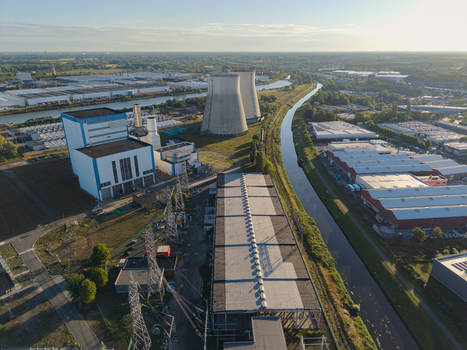 Aerial view of a power plant with cooling towers situated next to a canal in an industrial area of Vilvoorde Flanders Belgium.