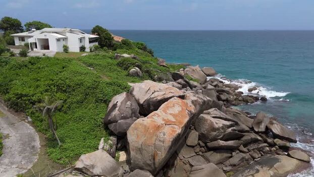 Aerial view of a white house on the coast of Mahe Seychelles.