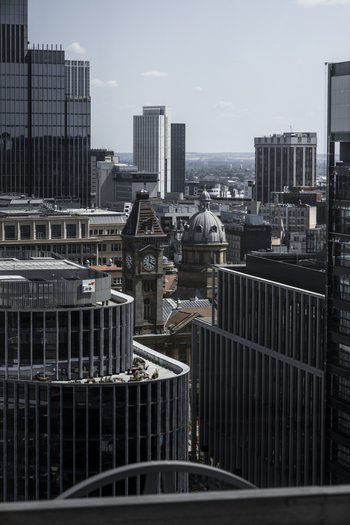 Aerial view of the Birmingham Council House clock tower and surrounding modern skyscrapers in the city center of Birmingham England United Kingdom.