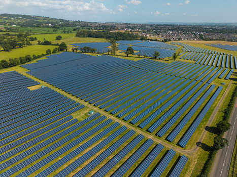 Aerial view of Lisburn Solar Farm with rows of photovoltaic panels set in green fields under a clear sky in Lisburn Northern Ireland United Kingdom. Aerial view of Lisburn Solar Farm with rows of photovoltaic panels set in green fields under a clear sky in Lisburn Northern Ireland United Kingdom.