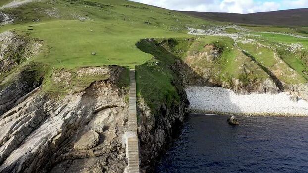 Aerial view of An Port coastal cliffs and stone stairs Ireland.